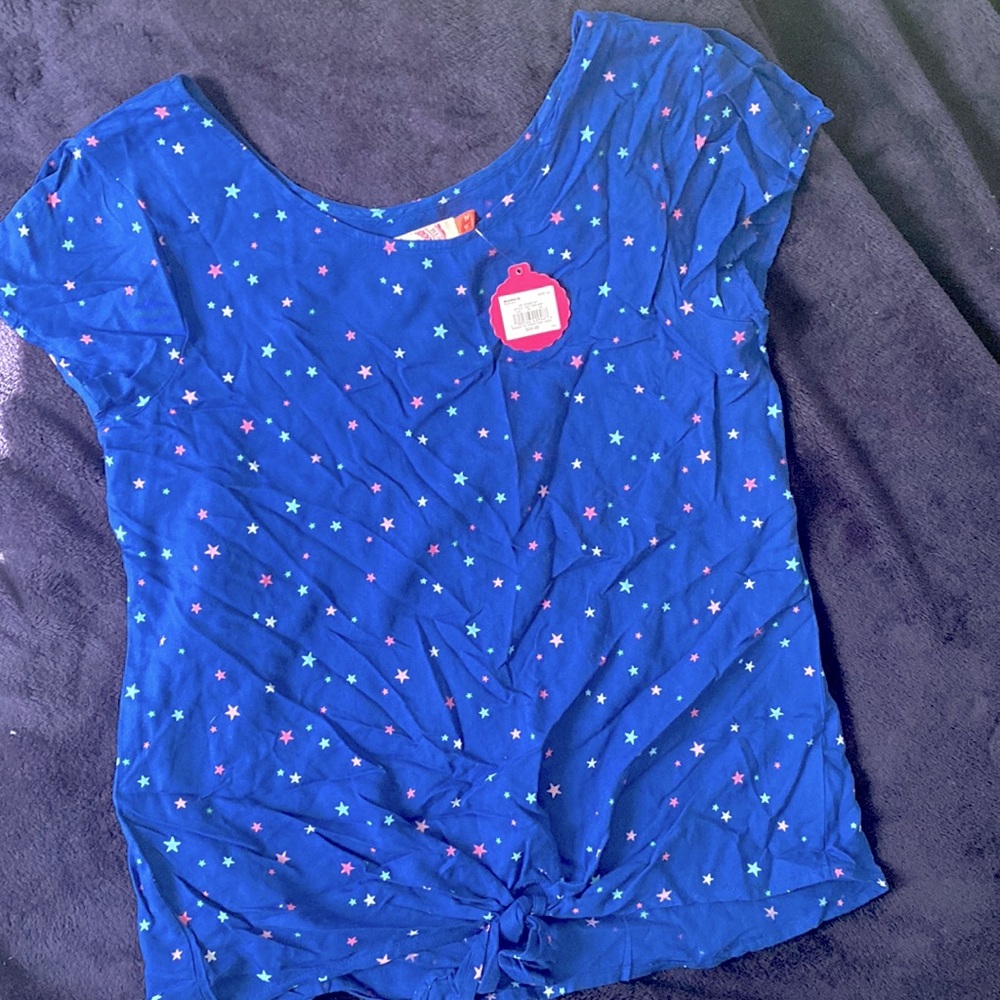 Blue girls blouse with tie in front and star pattern throughout.